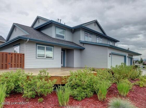 1091 Northpointe Bluff Dr, Anchorage, AK 99501 - view of front facade with an attached garage and a deck