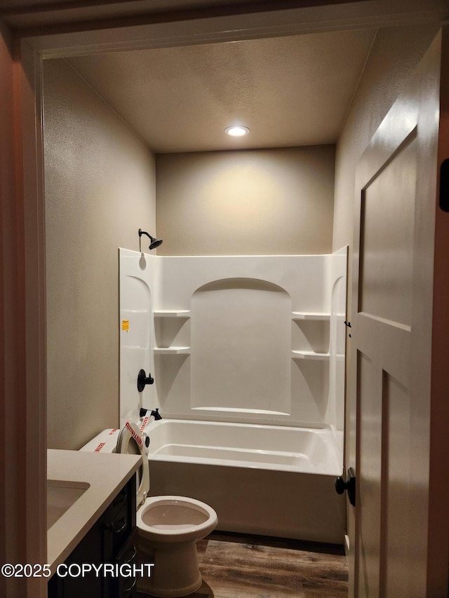 full bathroom with bathtub / shower combination, wood finished floors, toilet, and vanity