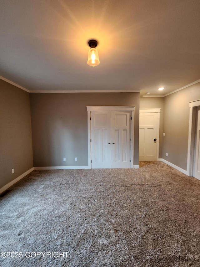 spare room with carpet flooring, baseboards, and ornamental molding