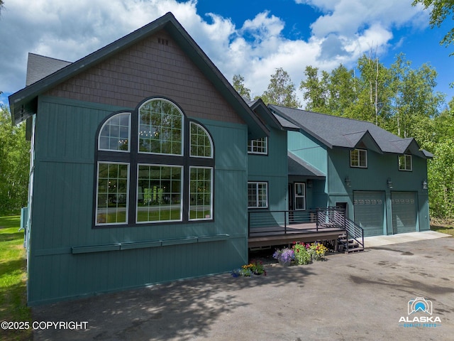 19136 S Birchwood Loop Rd, Chugiak, AK 99567 - view of front of property featuring a garage, asphalt driveway, and a wooden deck