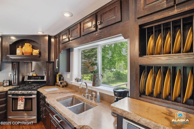 19136 S Birchwood Loop Rd, Chugiak, AK 99567 - kitchen featuring stainless steel range with gas cooktop, a sink, dark brown cabinets, light countertops, and recessed lighting