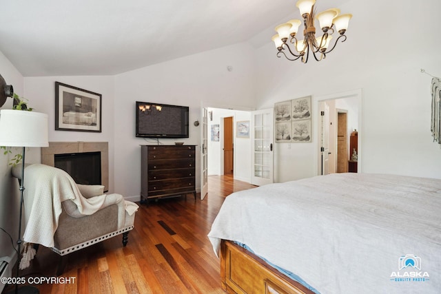 19136 S Birchwood Loop Rd, Chugiak, AK 99567 - bedroom featuring a chandelier, wood finished floors, high vaulted ceiling, a glass covered fireplace, and baseboard heating