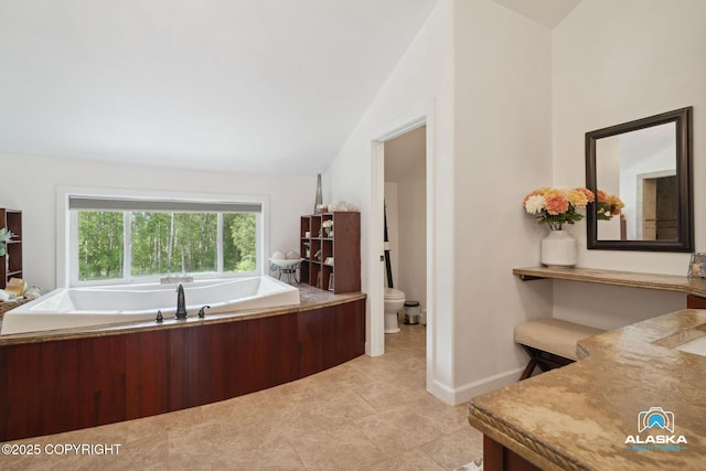 19136 S Birchwood Loop Rd, Chugiak, AK 99567 - bathroom with a garden tub, vaulted ceiling, toilet, tile patterned flooring, and vanity