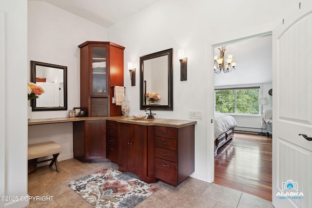 19136 S Birchwood Loop Rd, Chugiak, AK 99567 - bathroom featuring vanity, baseboard heating, a chandelier, ensuite bathroom, and tile patterned flooring