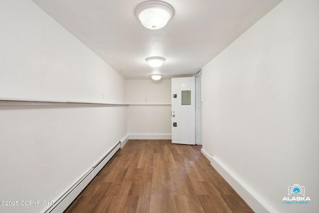 19136 S Birchwood Loop Rd, Chugiak, AK 99567 - corridor with baseboard heating, wood finished floors, and baseboards