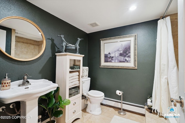 19136 S Birchwood Loop Rd, Chugiak, AK 99567 - full bathroom featuring a baseboard heating unit, toilet, a textured wall, and tile patterned flooring