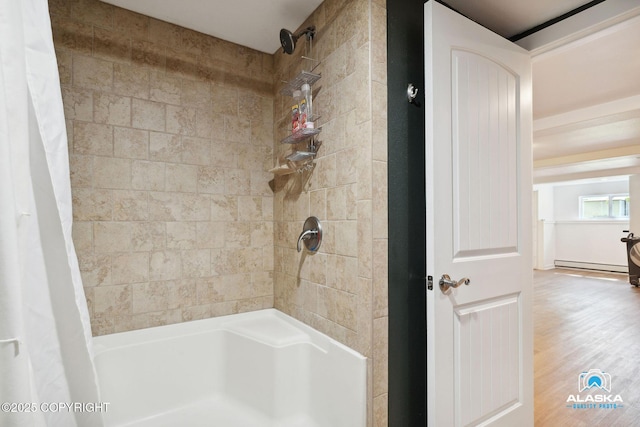 19136 S Birchwood Loop Rd, Chugiak, AK 99567 - bathroom with shower / bath combo, a baseboard radiator, and wood finished floors