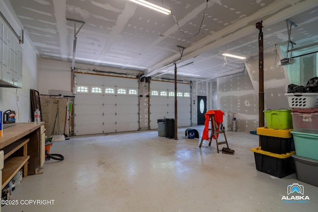 19136 S Birchwood Loop Rd, Chugiak, AK 99567 - garage featuring a garage door opener and a workshop area