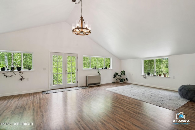 19136 S Birchwood Loop Rd, Chugiak, AK 99567 - unfurnished living room with a chandelier, plenty of natural light, high vaulted ceiling, and wood finished floors