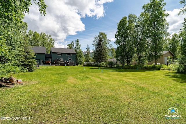 19136 S Birchwood Loop Rd, Chugiak, AK 99567 - view of green lawn with a wooden deck