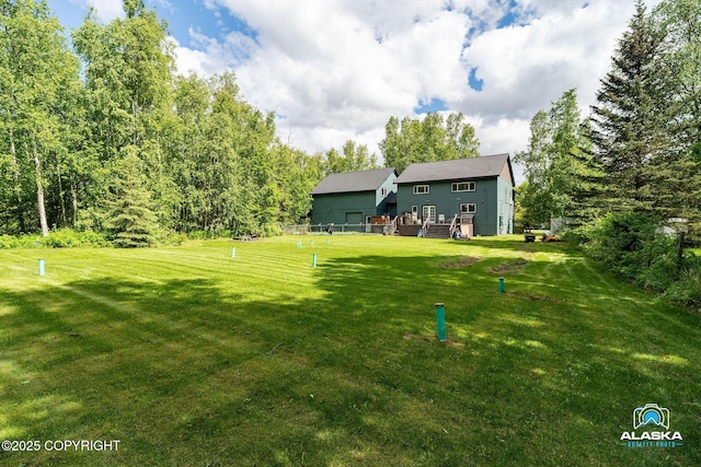 19136 S Birchwood Loop Rd, Chugiak, AK 99567 - view of green lawn with a wooden deck
