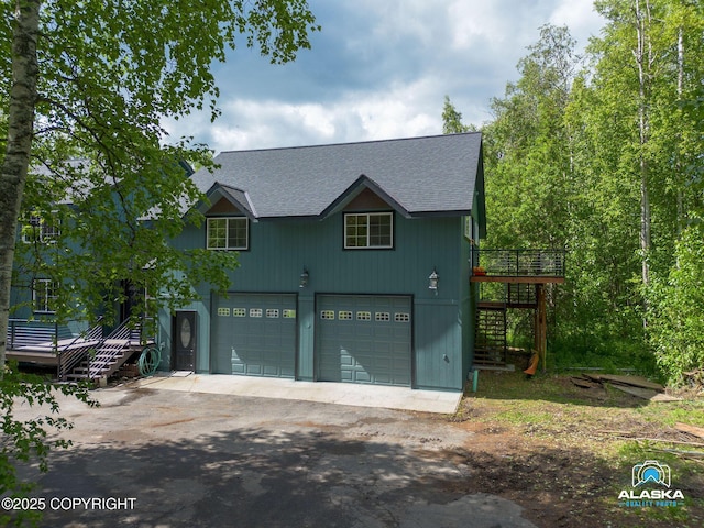 19136 S Birchwood Loop Rd, Chugiak, AK 99567 - view of front facade featuring stairway, a shingled roof, driveway, a garage, and a deck