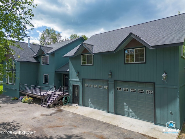 19136 S Birchwood Loop Rd, Chugiak, AK 99567 - view of front of property featuring roof with shingles, a garage, driveway, and a wooden deck