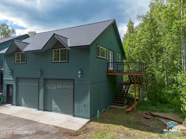19136 S Birchwood Loop Rd, Chugiak, AK 99567 - view of side of property featuring stairway, a shingled roof, a garage, a deck, and driveway