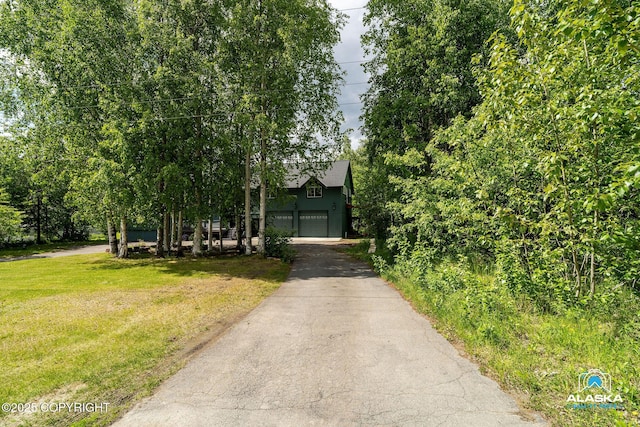 19136 S Birchwood Loop Rd, Chugiak, AK 99567 - view of front of house with driveway, a front yard, and a garage