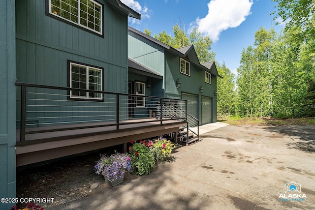 19136 S Birchwood Loop Rd, Chugiak, AK 99567 - view of home's exterior with an attached garage and asphalt driveway