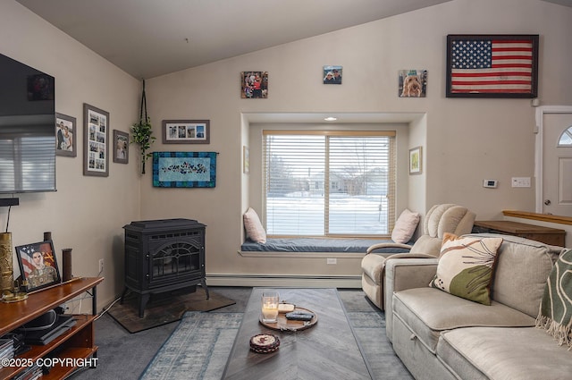 carpeted living room featuring a baseboard radiator, a wood stove, and vaulted ceiling