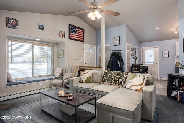 living area with baseboard heating, a ceiling fan, and vaulted ceiling