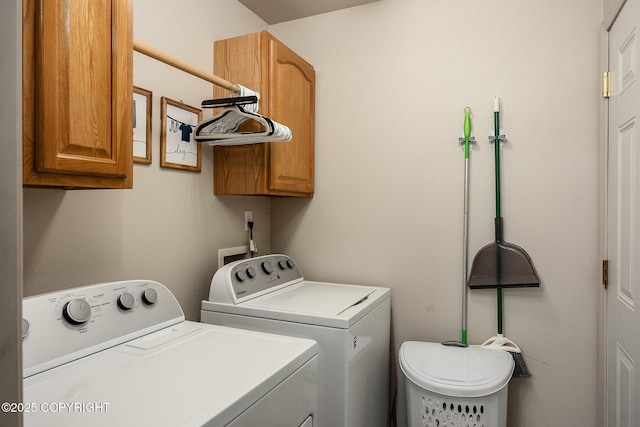 clothes washing area with cabinet space and separate washer and dryer