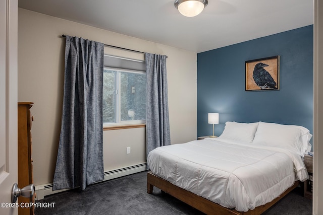 bedroom featuring a baseboard heating unit and dark carpet