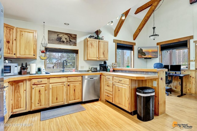 kitchen featuring light brown cabinets, a peninsula, vaulted ceiling with beams, a sink, and stainless steel dishwasher