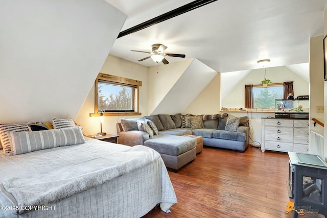 bedroom with ceiling fan, multiple windows, lofted ceiling, and wood finished floors