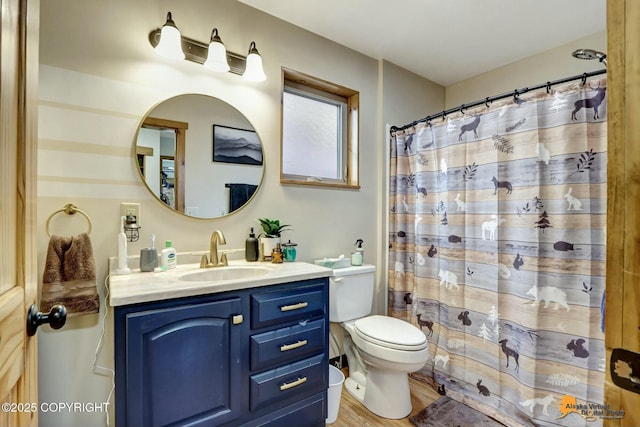 bathroom featuring vanity, a shower with shower curtain, toilet, and wood finished floors