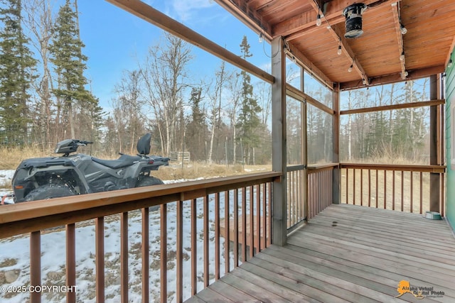 sunroom featuring track lighting and wood ceiling