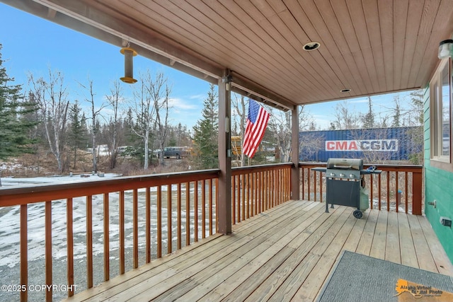 wooden terrace featuring a grill