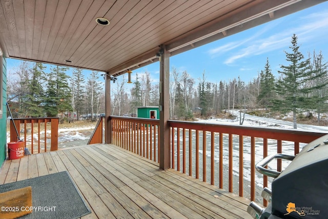 snow covered deck with an outdoor structure