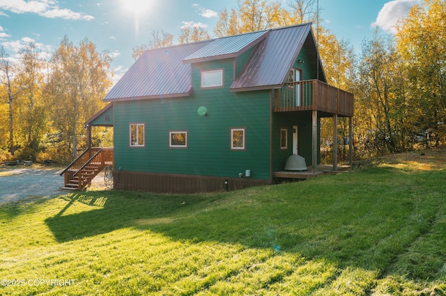 view of property exterior featuring a lawn and metal roof