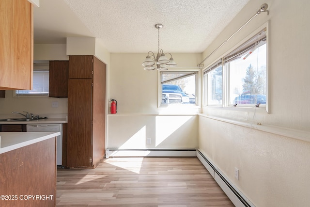 2752 W 42nd Ave Unit 4, Anchorage, AK 99517 - unfurnished dining area with a textured ceiling, light wood-type flooring, a chandelier, a sink, and a baseboard radiator