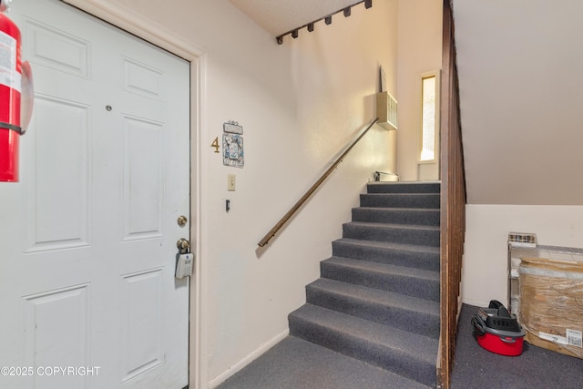 2752 W 42nd Ave Unit 4, Anchorage, AK 99517 - carpeted entryway featuring stairway and baseboards