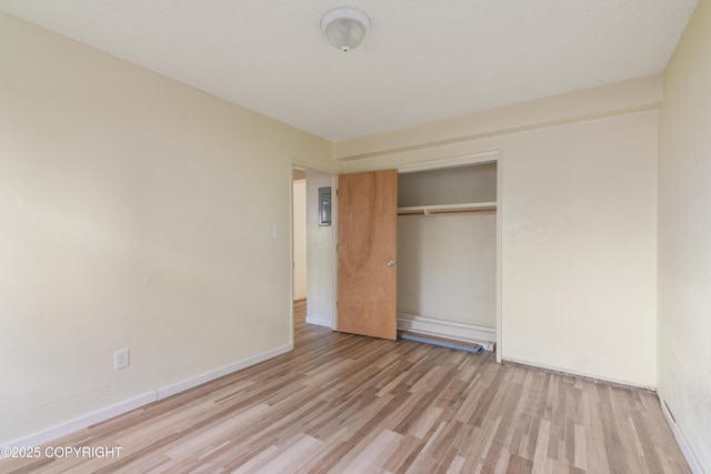 2752 W 42nd Ave Unit 4, Anchorage, AK 99517 - unfurnished bedroom with wood finished floors, a closet, baseboards, and electric panel