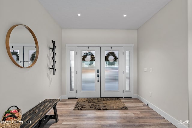 foyer entrance with light wood-style flooring, recessed lighting, baseboards, and french doors