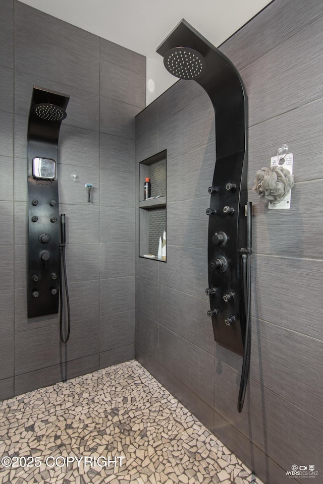 bathroom with tiled shower