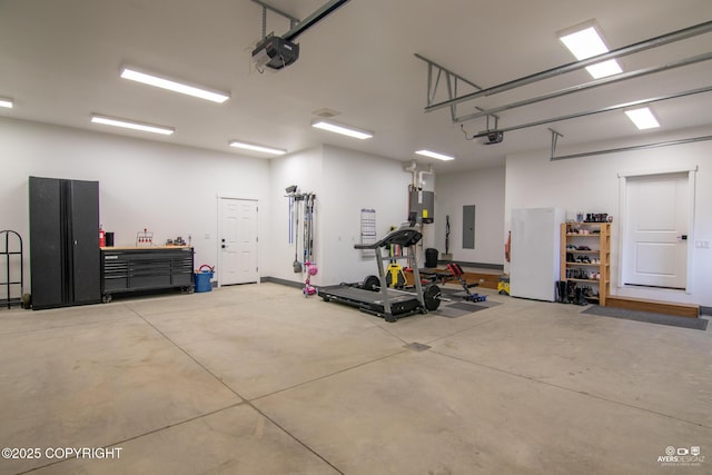 garage featuring electric panel, a garage door opener, water heater, and freestanding refrigerator