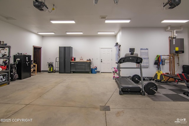 garage with a garage door opener and water heater