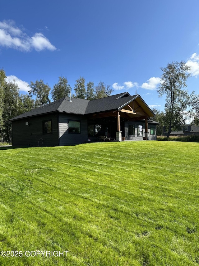 rear view of property with a yard