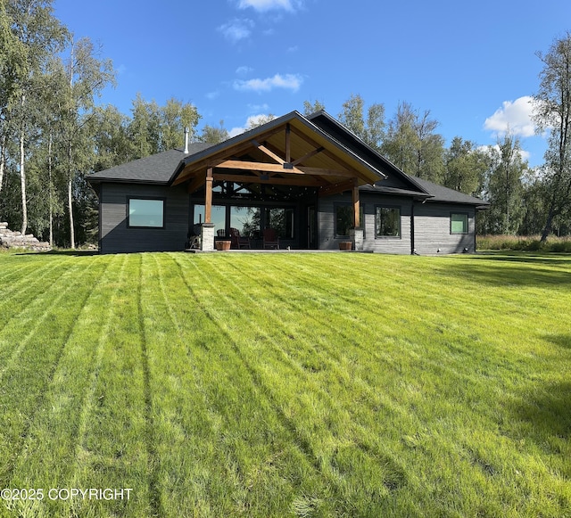 rear view of property with a lawn