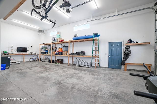 garage with a workshop area and a garage door opener