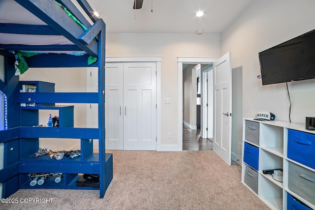 carpeted bedroom featuring a closet and ceiling fan