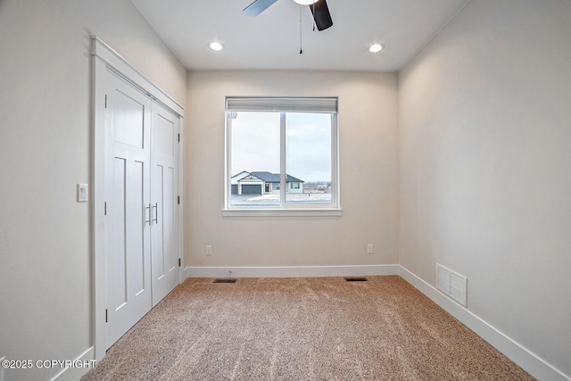 unfurnished bedroom featuring visible vents, baseboards, and carpet