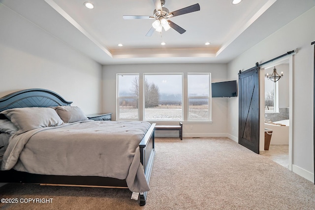 bedroom featuring baseboards, light colored carpet, a barn door, recessed lighting, and a raised ceiling