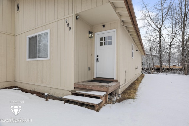 view of snow covered property entrance