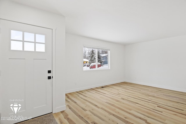 entryway with baseboards and light wood-style floors