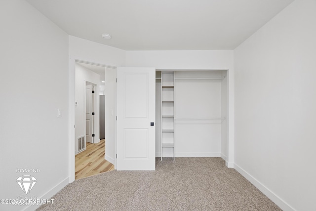 unfurnished bedroom featuring carpet flooring, baseboards, and visible vents