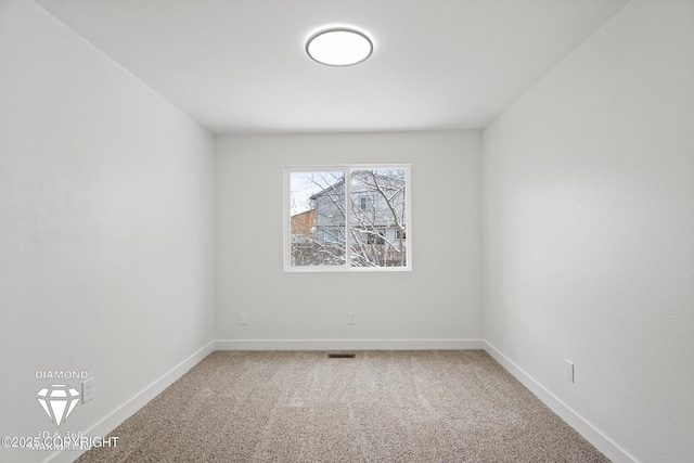 carpeted empty room with visible vents and baseboards