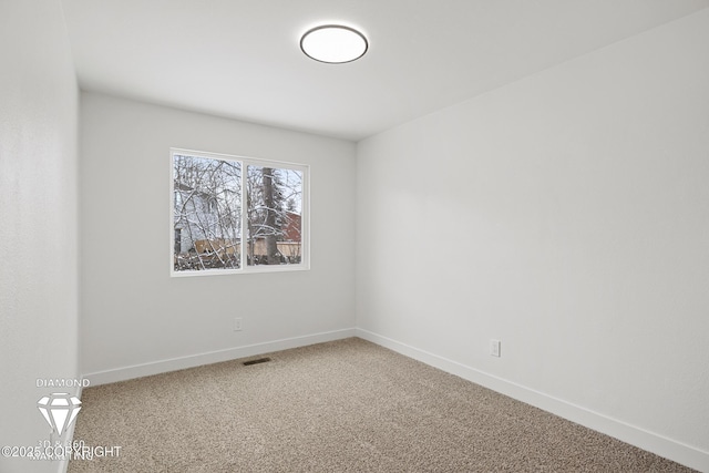 unfurnished room featuring visible vents, baseboards, and carpet