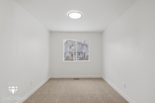 unfurnished room featuring light colored carpet and baseboards